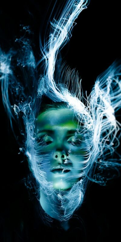 A hauntingly beautiful portrait of a woman with abstract light effects creating a surreal, ethereal appearance.